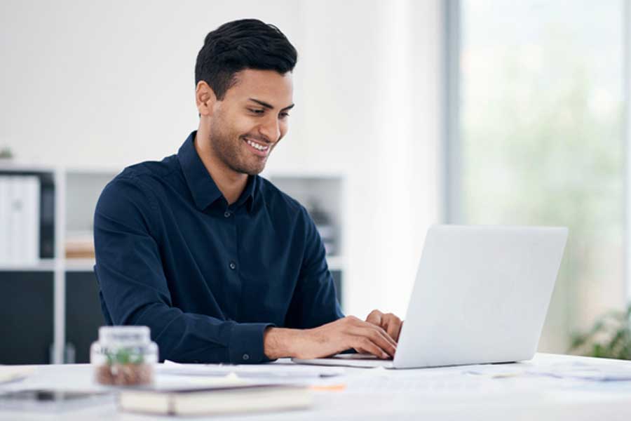 Businessman using a laptop at desk in office