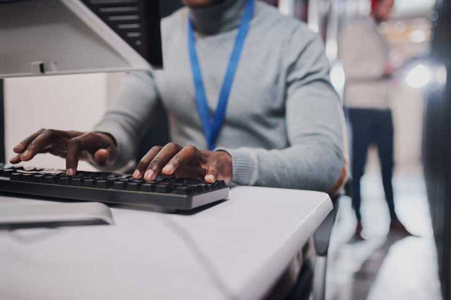 unrecognisable IT support man working on a computer