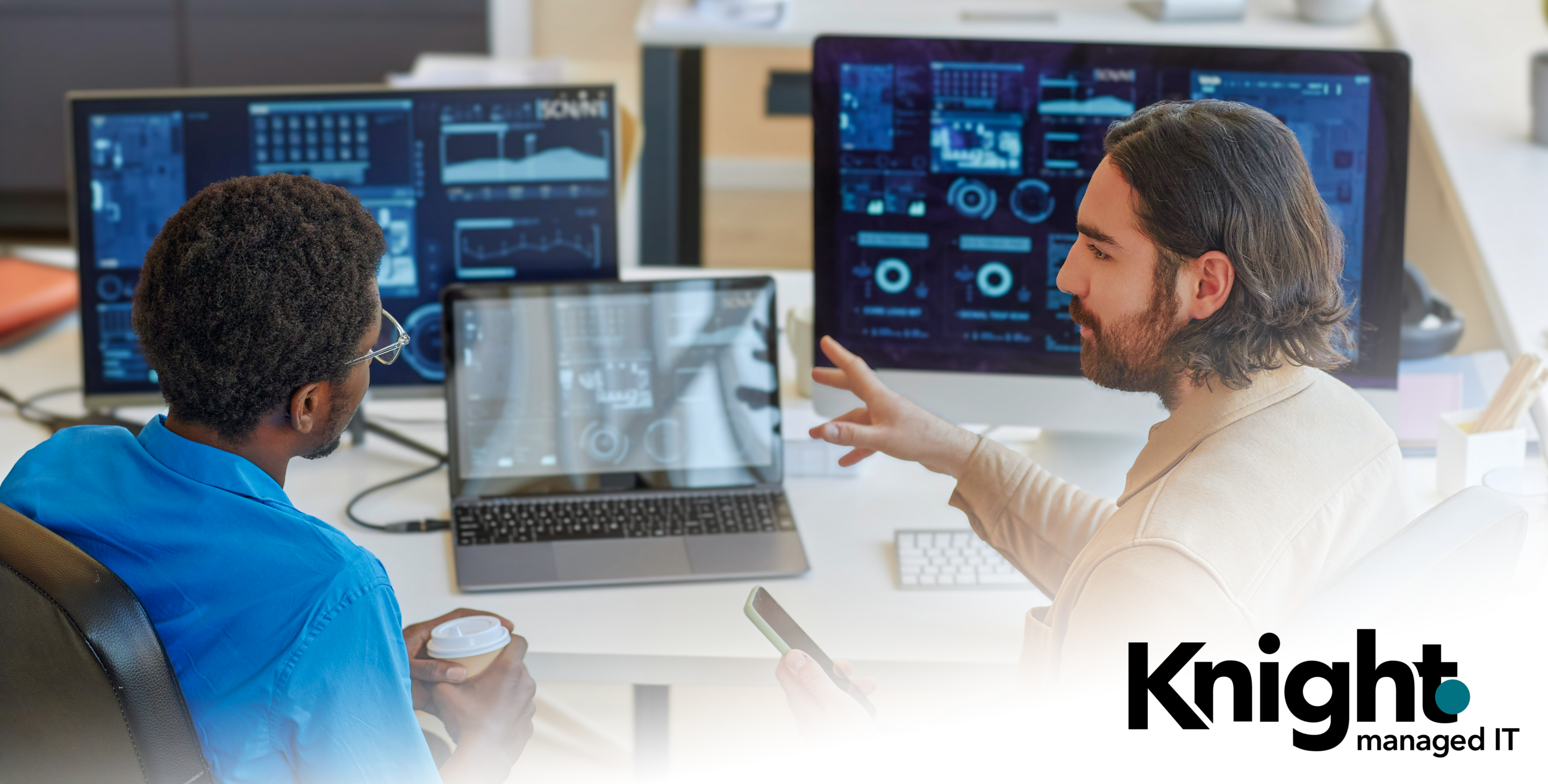 IT professionals reviewing system monitoring and cybersecurity dashboards