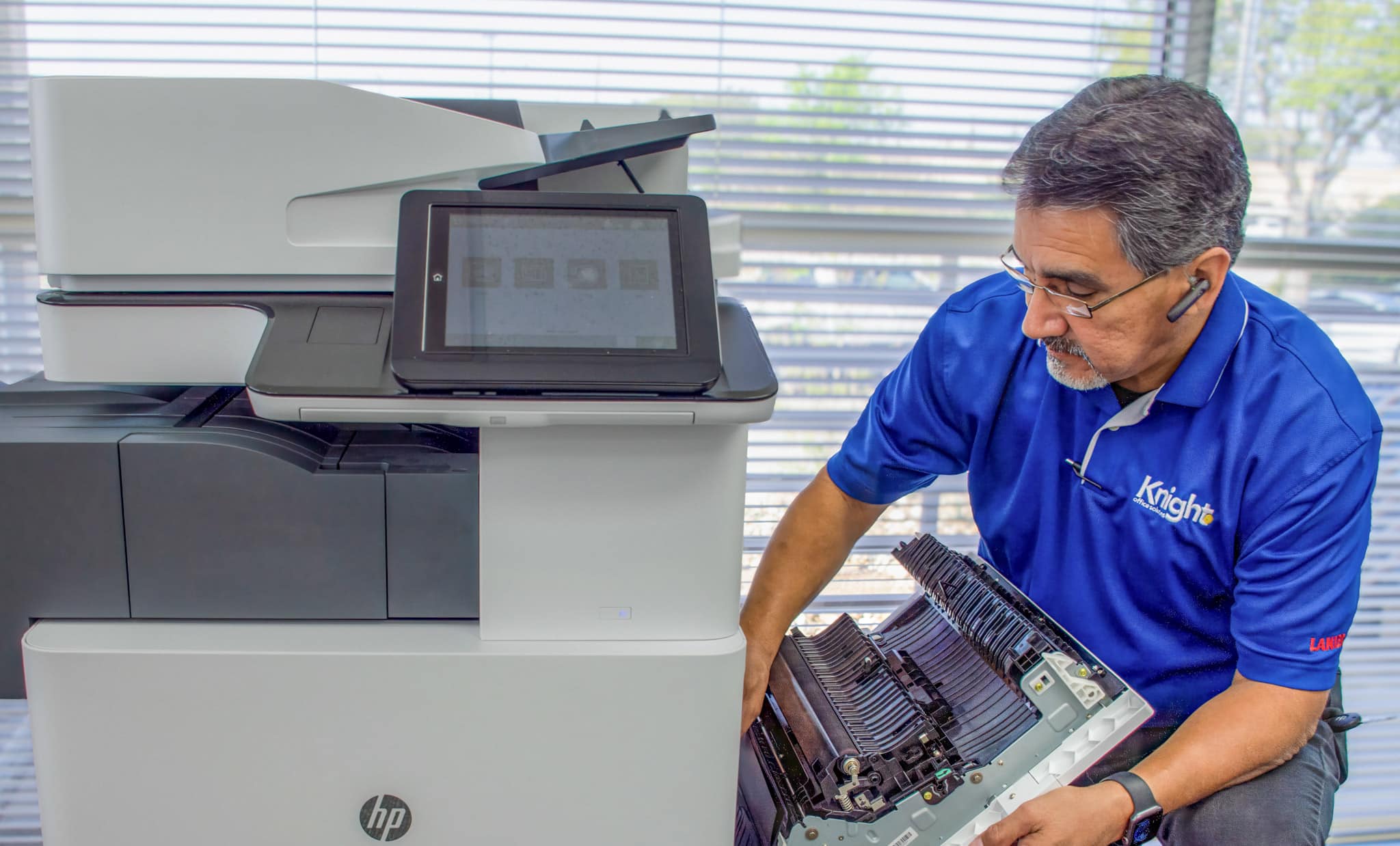 Knight Office technician Paul Bernal servicing office equipment